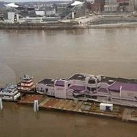Jeff Ruby’s Waterfront restaurant and barge being pushed back upriver by C&B Marine towboats. Photo courtesy C&B Marine.