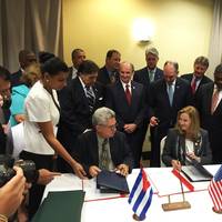 Manuel Fernandez Perez Guerra, Director General of the National Port Administration of Cuba, and Brandy Christian, Port of New Orleans Chief Operating Officer, sign a memorandum of understanding in Havana Oct. 4. Louisiana Gov. John Bel Edwards (standing directly behind Christian) and Michael Kearney, Chairman of the Port of New Orleans Board of Commissioners (standing front right), were among the 50-member Louisiana trade delegation that visited Cuba Oct. 3-7. Photo NOLA