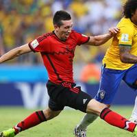 Marcelo of Brazil is challenged by Hector Herrera of Mexico (Photo courtesy of FIFA)