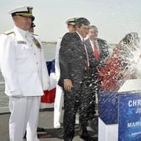 Marilla Waesche Pivonka (right), ship's sponsor, breaks a traditional bottle spraying the bow and platform guests at the christening of the Northrop Grumman-built U.S. Coast Guard National Security Cutter Waesche (WMSL 751). The ship is named for her grandfather, Adm. Russell Randolph Waesche, who served as the commandant of the U.S. Coast Guard from 1936 until 1946. Also on the platform are (left to right) U.S. Coast Guard Commandant Adm. Thad Allen; Mike Petters, vice president and president o