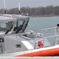 Members of Coast Guard Station Belle Isle in Detroit, and a member of the Royal Canadian Mounted Police pose for a photo on a 45-foot patrol boat after conducting a joint patrol in Lake Erie, May 8, 2014. (USCG Guard photo courtesy of Coast Guard Sector Detroit)
