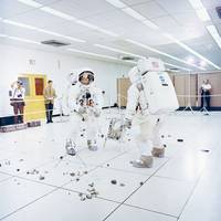 Members of the Apollo 12 lunar landing mission, Charles Conrad Jr. (facing camera) simulates picking up samples, and aAlan L. Bean simulates photographic lunar rock sample documentation, as they participate in lunar surface extravehicular activity (EVA) simulations in the Flight Crew Training Building at the Kennedy Space Center (KSC).  (Photo: Review of U.S. Human Space Flight Plans Committee)