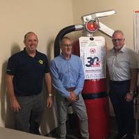 New Resolve Partners Chauncey Naylor (director of the Resolve  Academy), Stacy Payne (Resolve) and Glyn Day and Neil Cooper both with Fire Ranger.
The Large Fire Extinguisher is called Big Red. (Image: Resolve Marine)
