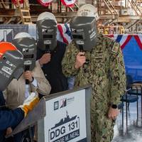 Ingalls Structural Welder Morris Johnson welds the initials of Kelley Neal Gray onto the keel plate that will be permanently part of George M. Neal (DDG 131). (Photo: HII)