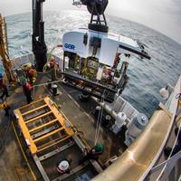 Okeanos Explorer's dual-body ROV system is loaded from the aftdeck of the ship into the water before conducting an exploration dive. (Credit: NOAA)