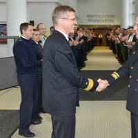 Outgoing DCOM Rear Admiral Martens shakes hands with incoming DCOM Rear Admiral Bauzá as the Operational HQ staff applaud (Photo courtesy EU NAVFOR)