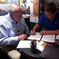 Paul Knight signing the agreement with CTruk chairman Andy White
