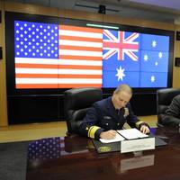 Rear Adm. Christopher Tomney signs a MOU with Michael Pezzullo, CEO of the Australian Customs and Border Protection Service, at Coast Guard Headquarters in Washington, D.C. (U.S. Coast Guard photo by Petty Officer 1st Class Timothy Tamargo)