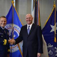 Rear Adm. Paul Thomas shakes hands with Captain Blaine Collins, DNV GL vice president of group governmental and public affairs for the U.S., following the signing of the new memorandum of agreement. The MOA authorizes DNV GL to participate in the Alternate Compliance Program. (Photo: U.S. Coast Guard)