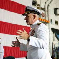 Rear Adm. Philip Sobeck (right) Commander of U.S. Military Sealift Command (MSC) explains the tradition of the Navy ‘looping ceremony’. Lt. Robert P. Ellison assumes the title of MSC's Flag Aide during the ceremony. The looping ceremony took place aboard USS Dwight D. Eisenhower (CVN 69) during MSC’s change of command ceremony held aboard the ship on Sept. 8, 2023. (U.S. Navy photograph by Brian Suriani/Released)