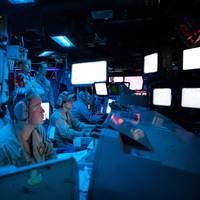 RED SEA (Oct. 19, 2023) Sailors aboard the Arleigh Burke-class guided-missile destroyer USS Carney (DDG 64) stand watch in the ship's combat information center during an operation to defeat a combination of Houthi missiles and unmanned aerial vehicles in the Red Sea, Oct. 19, 2023. (Source: US Navy)