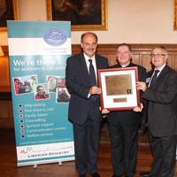 Revd Canon Ken Peters receiving his honorary masters licence from Michalis Pantazopoulos (left) and Jonathan Spremulli, general manager of LISCR’s London office (right)