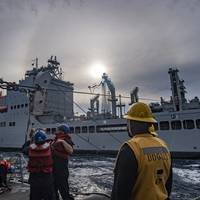 Sailors aboard the Arleigh Burke-class guided-missile destroyer USS Lenah Sutcliffe Higbee (DDG 123) conduct a replenishment-at-sea with the fleet replenishment oiler USNS John Lewis (T-AO 205) in the South China Sea, May 29, 2025. Higbee, assigned to the Nimitz Carrier Strike Group, is underway in the U.S. 7th Fleet area of operations on a scheduled deployment, demonstrating the U.S. Navy’s unwavering commitment to a free and open Indo-Pacific. (U.S. Navy photo by Mass Communication Specialist 