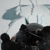 Sailors aboard the fast attack submarine USS Seawolf (SSN 21) inspect the boat after surfacing through Arctic ice. Seawolf conducted routine Arctic operations. (U.S. Navy photo/Released)