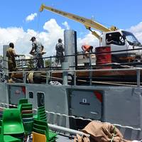 Sailors from HMAS Tarakan load supplies donated by the Rotary Club of Honiara onto their ship during a port visit to Honiara, Solomon Islands. Photo: Craig Blakely