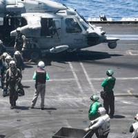 Sailors from the Dwight D. Eisenhower Carrier Strike Group render assistance to distressed mariners at sea in the Red Sea, June 15. (Official U.S. Navy photo)