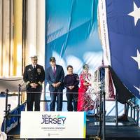Ship's sponsor Susan DiMarco christens pre-commissioning unit New Jersey (SSN 796) during ceremony on Saturday, Nov. 13, 2021 at Newport News Shipbuilding. (Photo: HII)
