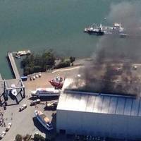 Smoke from a fire onboard HMAS Bundaberg bellows from a maintenance shed in Hemmant, Brisbane. (Australian Navy photo)