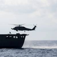SOUTH CHINA SEA (May 7, 2019) An MH-60R Sea Hawk helicopter assigned to the "Easyriders" of Helicopter Maritime Strike Squadron (HSM) 37, Detachment 1, picks up pallets from the Military Sealift Command fleet replenishment oiler USNS Guadalupe (T-AO 200) during a replenishment-at-sea with the Arleigh Burke-class guided-missile destroyer USS Preble (DDG 88). Preble is deployed to the U.S 7th Fleet area of operations in support of security and stability in the Indo-Pacific region. (U.S. Navy photo