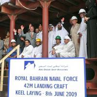 Staff Colonel Hasan Ahmed Mohammed, Head of the Planning Department, Royal Bahrain Naval Force and ADSB CEO Bill Saltzer with ADSB management and employees inside the first hull block constructed for the landing craft.