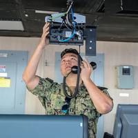 Strategic Sealift Officer Lt. David Gill runs radio tests in the bridge of Military Sealift Command large, medium-speed roll-on/roll-off (LMSR) vessel USNS Benavidez (T-AKR 306) (Source US Department of Defense 2019)