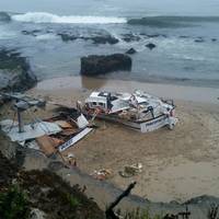 The 56-foot commercial fishing vessel, Pacific Quest, is broken and beached near Seymour Marine Discovery Center in Santa Cruz, Calif., August 13. Responders are working to remove fuel from tanks on the beach during low tide. (U.S. Coast Guard courtesy photo)