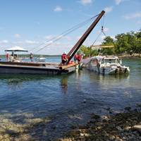 The Coast Guard oversees the removal of Stretch Duck 7 from Table Rock Lake in Branson, Missouri, July 23, 2018. Missouri State Highway Patrol divers rigged the vessel, then a barge crane lifted it to the surface before it was towed to shore and loaded onto a flatbed trailer for transport to a secure facility. U.S. Coast Guard photo by Petty Officer 3rd Class Lora Ratliff