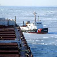 The crew of Coast Guard Cutter Neah Bay, homeported in Cleveland, works to keep the CSL Laurentien moving during an escort in eastern Lake Erie March 27, 2014. (U.S. Coast Guard photo courtesy of CSL Laurentien)