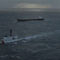 The Kodiak-based Coast Guard Cutter Alex Haley escorts the 738-foot cargo vessel Golden Seas while under tow to Dutch Harbor by the tug Tor Viking II Dec. 5, 2010, 50 miles west southwest of Dutch Harbor in the Pacific Ocean. The Golden Seas requested a tow after suffering a turbo-charge failure Dec. 3 limiting power and steerage. U.S. Coast Guard photo by Petty Officer 1st Class Sara Francis.