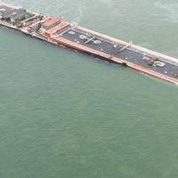 The partially submerged barge: Photo credit USCG 
