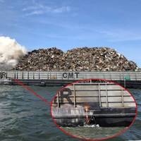 The scrap metal fire aboard the CMT Y Not 6 on the morning of May 23, 2022. Inset shows molten metal leaking out of a starboard-side freeing port. (Source: U.S. Coast Guard)