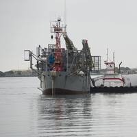 Tugs guide the Department of the Navy's Floating Instrument Platform (FLIP) from her berth at the Nimitz Marine Facility in Point Loma, Calif. (U.S. Navy photo by John F. Williams/Released)