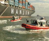 Two Coast Guard small boats set a security zone around the 900-foot container ship Cosco Busan. (U.S. Coast Guard photo)