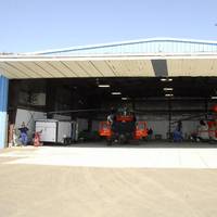 Two Kodiak-based MH-60 Jayhawk helicopters sit in a Barrow Airport hangar ready to respond to any maritime search and rescue emergency July 10, 2012.