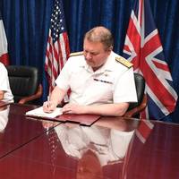 Vice Adm. Louis-Michel Guillaume, left, commander of French Submarine and Strategic Oceanic Forces, Vice Adm. Kevin M. Donegan, middle, commander of the U.S. Naval Forces Central Command, and Rear Adm. Robert K. Tarrant, commander Operations of the Royal Navy, sign an agreement to increase coordination for anti-submarine warfare activities between France, the U.S. and the United Kingdom. Photo: United States Navy