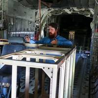 VX-30 engineer Sam Newcomer explains the Satellite Communications Range Extension Aircraft Modification (SCREAM) system inside a KC-130T Hercules at Naval Base Ventura County. The system enabled beyond-line-of-sight communications during Exercise Talisman Sabre 2025, supporting the U.S. Army’s first Typhon missile launch outside the continental United States. (U.S. Navy photo by Michael L. Smith)