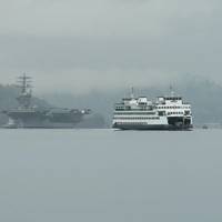 Washington State Ferry M/V Kaleetan passes by as USS Nimitz (CVN 68) transits Sinclair Inlet as it gets underway from Puget Sound Naval Shipyard. (U.S. Navy photo by Vaughan Dill)