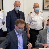 Windstar Cruises’ President Chris Prelog (on left) finishes signing handover documents for Star Legend at the Fincantieri shipyard in Palermo, Italy. (Photo: Windstar Cruises)