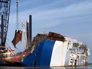A crane positions the 16th and final lifting lug onto the Golden Ray hull in St. Simons Sound, Ga. (Photo: St. Simons Sound Incident Response)