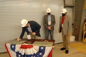 GLDD’s Bill Hanson, SVP; Chris Roberts, VP, TSHD Fleet Manager and Vidar Lindmoen, Program Director initial the keel. (Photo: Conrad Shipyard)