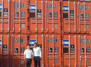 Daniel Lim and Sahil Gandhi (L to R) in front of a line of OEG Containers