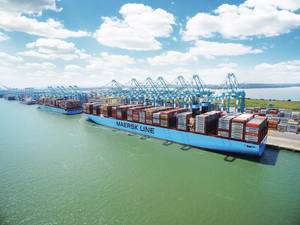 File Image: A typical Maersk boxship works cargo alongside a pier. (CREDIT: Maersk)