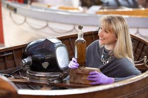 Abigail McIntyre, Senior Curator at the Scottish Maritime Museum, pictured with an eighty year old bottle of Scottish whisky salvaged from the 1923 SS Politician, one of Scotland’s most famous shipwrecks and the inspiration for the much-loved Ealing Studio comedy Whisky Galore! The whisky bottle, which was acquired by the Scottish Maritime Museum with the support of the National Fund for Acquisitions at The Grand Whisky Auction, will become part of the Museum’s nationally recognized collection o