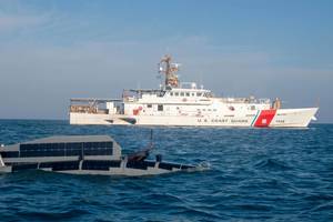 An Ocean Aero Triton unmanned surface vessel operates alongside U.S. Coast Guard fast response cutter USCGC Emlen Tunnell (WPC 1145) in the Arabian Gulf, November 29, during Digital Horizon 2022. (Credit: Brandon Murphy / U.S. Army)