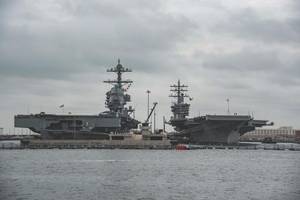 The aircraft carrier Pre-Commissioning Unit (PCU) Gerald R. Ford (PCU 78), left, and USS Dwight D. Eisenhower (CVN 69) sit pierside at Naval Station Norfolk. (U.S. Navy photo by Nathan T. Beard)