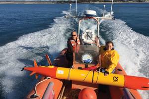 MBARI researchers head out into Monterey Bay to deploy a long-range autonomous underwater vehicle (LR-AUV), an underwater robot that is programmed at the surface and then travels underwater for hundreds of miles, measuring water chemistry and collecting water samples as it goes.  Credit: Brian Kieft (c) 2015 MBARI