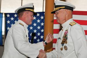 Rear Adm. T. K. Shannon (left) and Rear Adm. Mark Buzby congratulate each other during a change of command ceremony aboard the USNS Spearhead (JSHV 1). Shannon relieved Buzby as commander, Military Sealift Command.  (U.S. Navy Photo by Mass Communication Specialist Seaman Apprentice Jesse A. Hyatt)