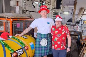 RRS James Cook Captain John Leask (right) and electro technical officer Harvey Jack (left) with the NOC’s Autosub Long Range (ALR) underwater robot (aka Boaty McBoatface), complete with some festive tinsel. Image courtesy NOC