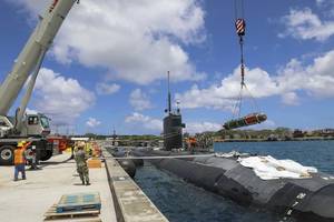 Sailors assigned to the Los Angeles-class fast-attack submarine USS Annapolis (SSN 760) load a MK 67 submarine launched mobile mine (SLMM) onto Annapolis, May 4. Annapolis will be conducting maritime operations in the U.S. 7th Fleet area of operations to maintain a safe and open Indo-Pacific. (U.S. Navy photo by Mass Communication Specialist 2nd Class Zachary Grooman).