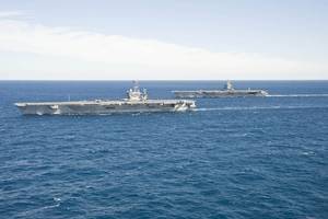 The aircraft carrier USS Enterprise (CVN 65) passes the aircraft carrier USS Harry S. Truman (CVN 75) in the Atlantic Ocean. (U.S. Navy photo by Naval Aircrewman (Tactical Helicopter) 3rd Class Matt Ballard/Released) 